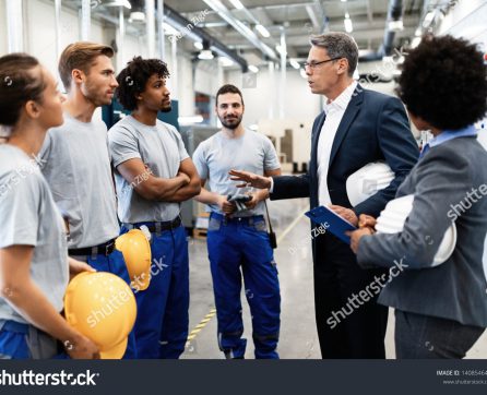 stock-photo-company-inspector-taking-a-tour-in-industrial-plant-and-communicating-with-group-of-workers-1408546451